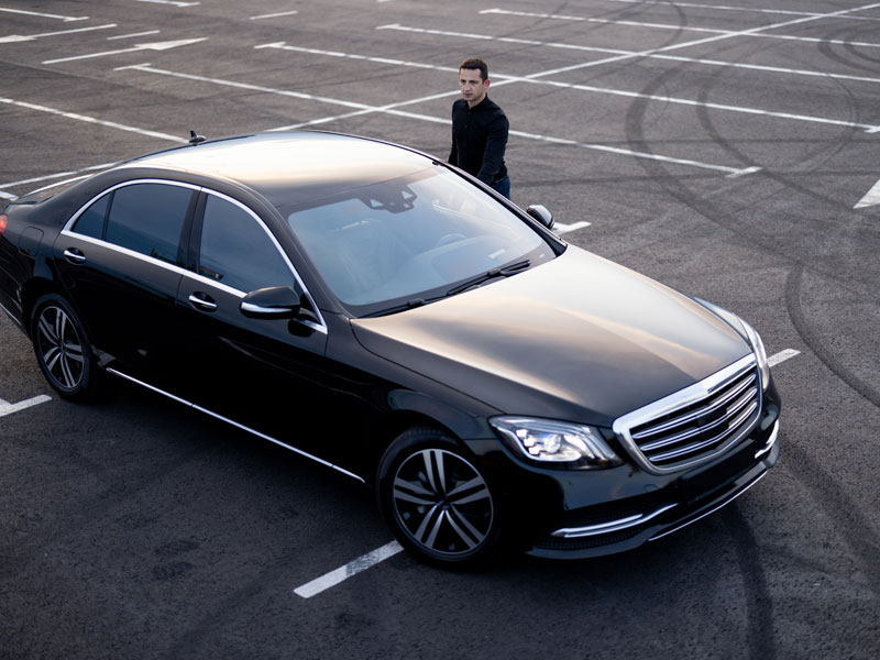 Chauffeur Near Luxury Car