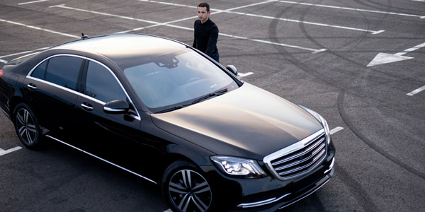 Chauffeur Near Luxury Car