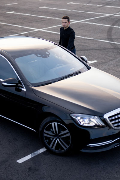 Chauffeur Near Luxury Car